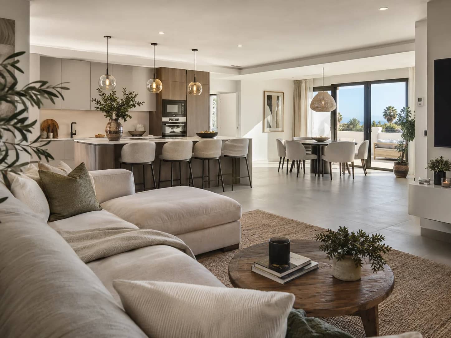 Open-plan living, dining and kitchen space opening onto a terrace