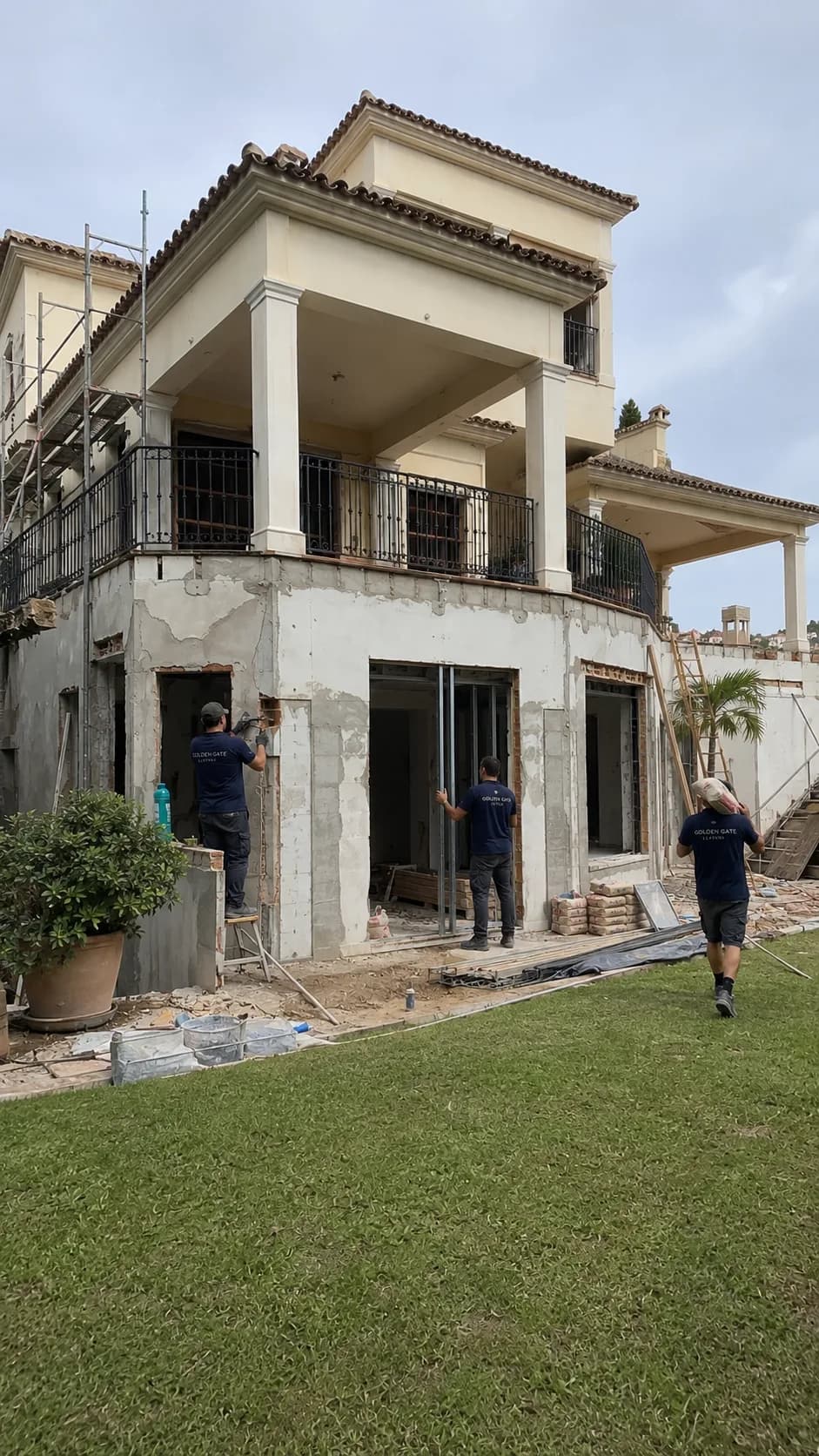 Building team carrying out structural facade works on a villa — during construction