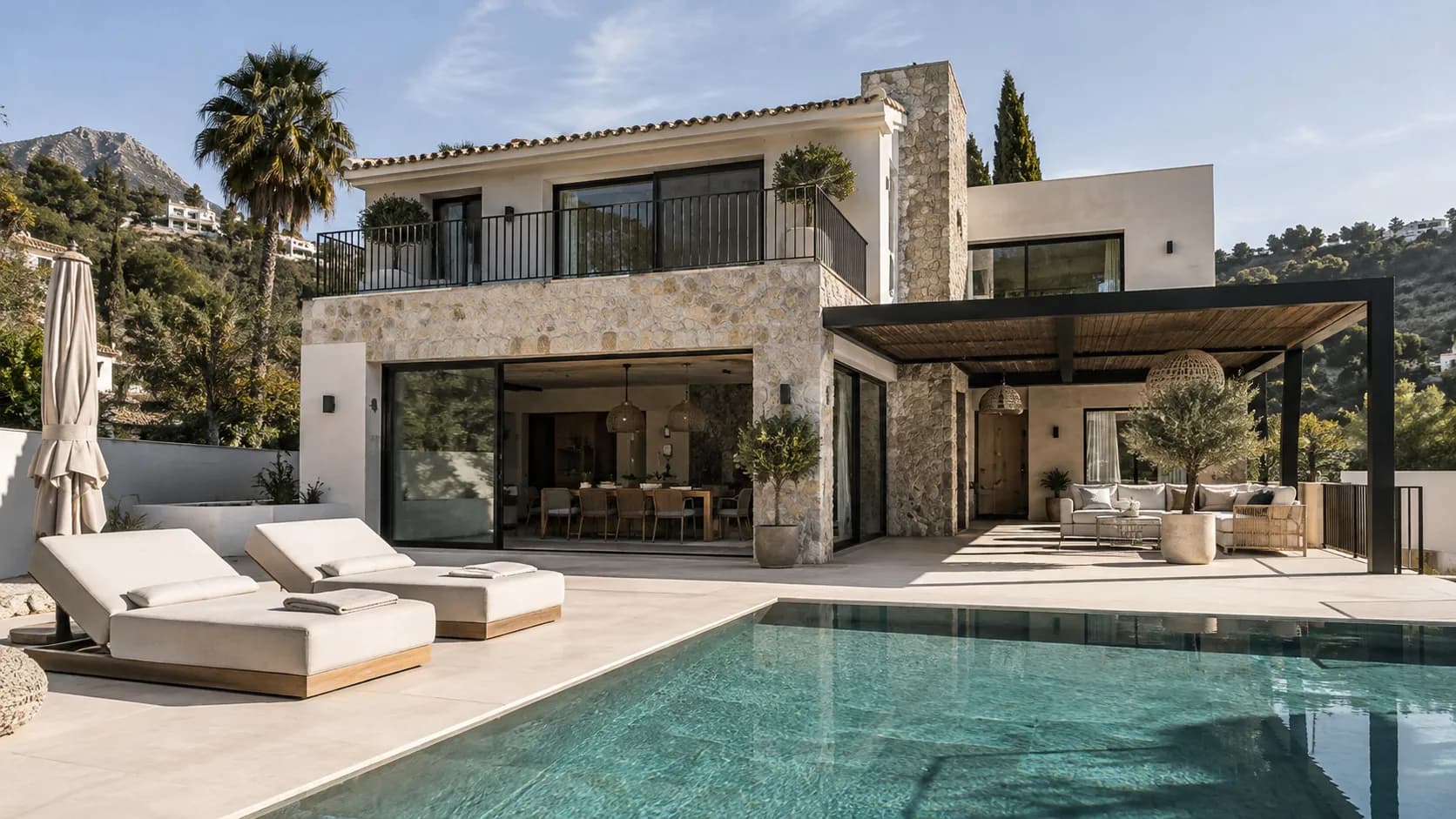 Completed villa with a natural stone facade, covered terrace and pool