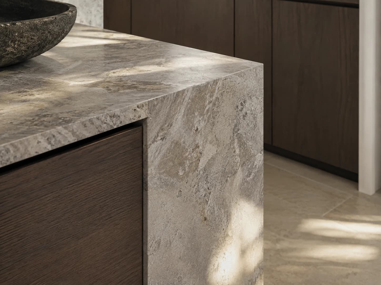 Stone worktop meeting dark timber joinery