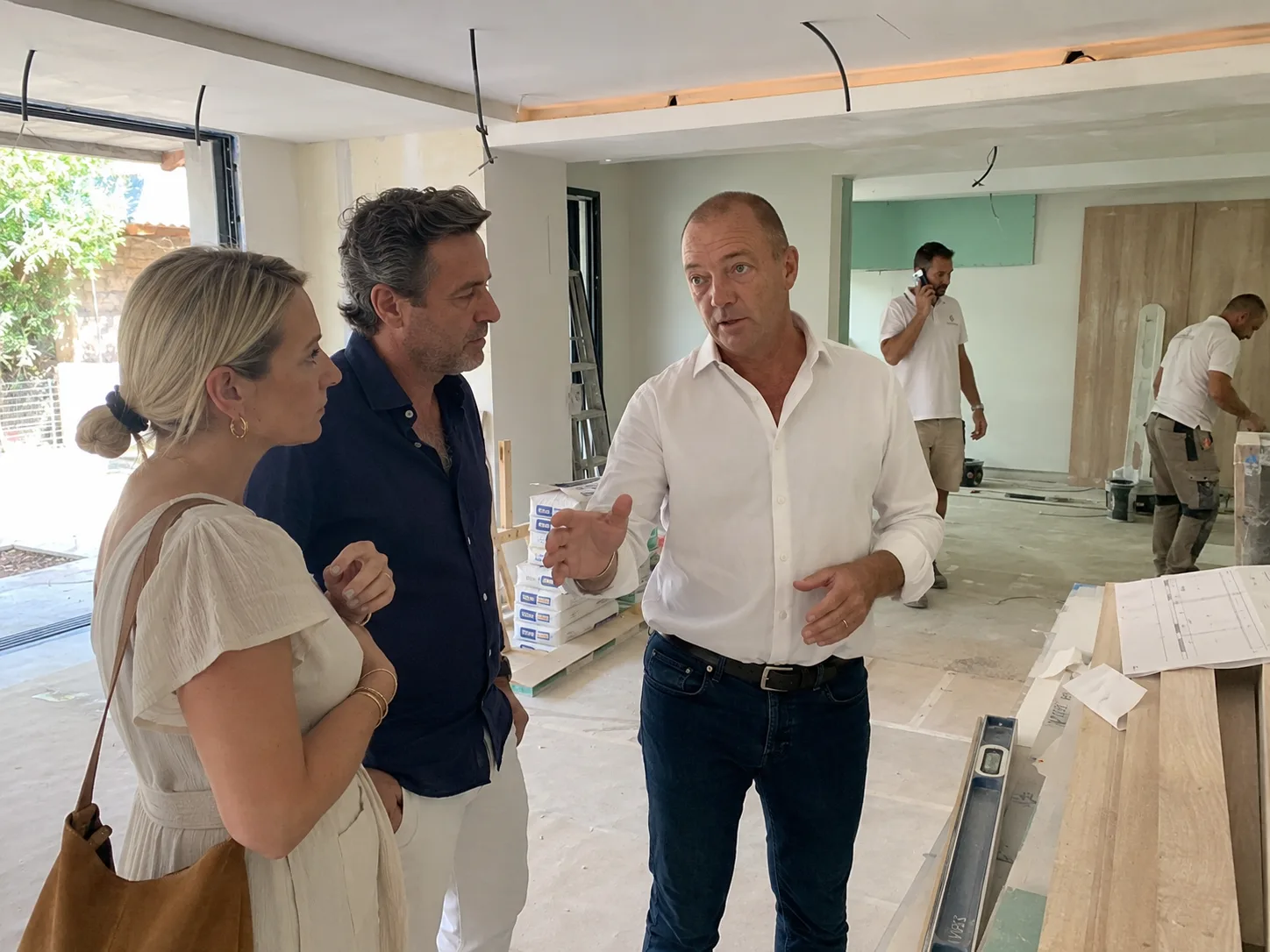 Clients discussing progress with the building team during finishing works on site — during construction