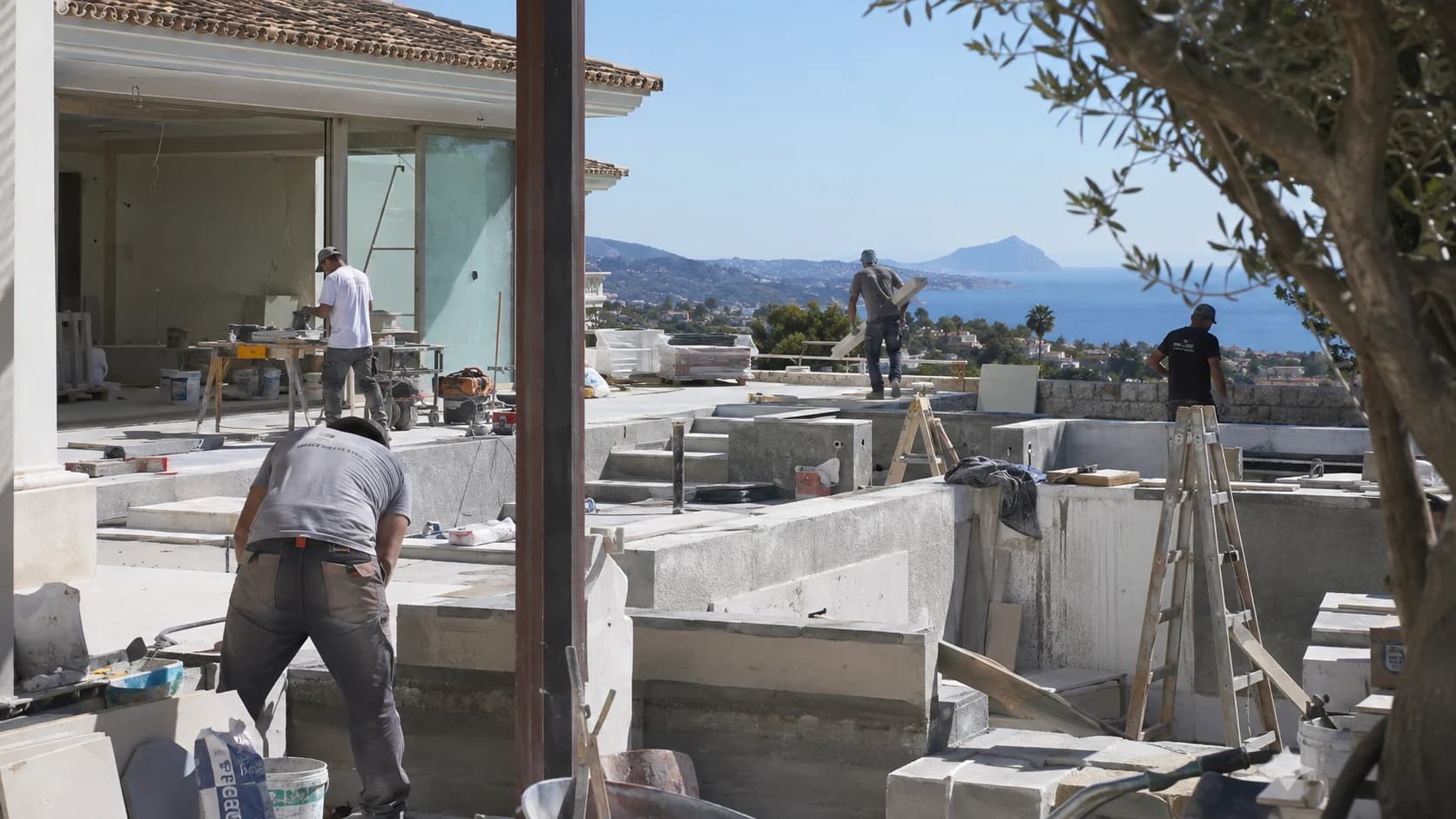 Villa construction site above the coast, with the build team working on the terrace level
