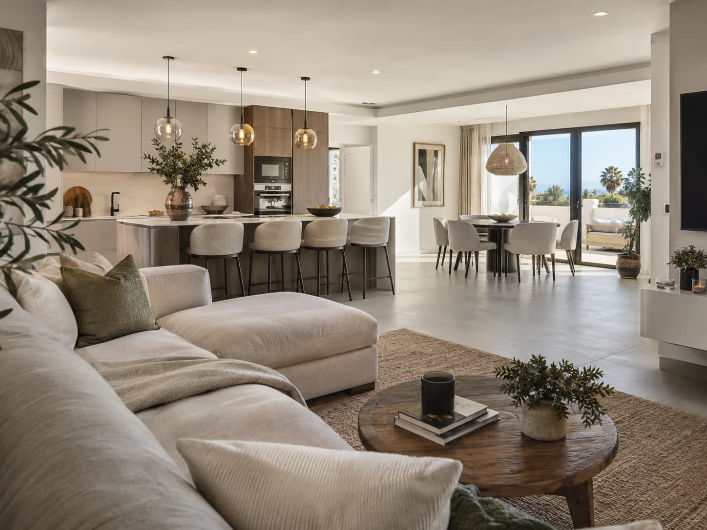 Open-plan living, dining and kitchen space opening onto a terrace